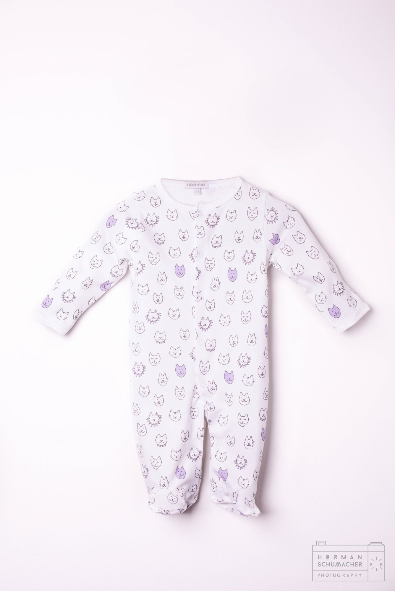 white baby noomie onesie with cats and lions