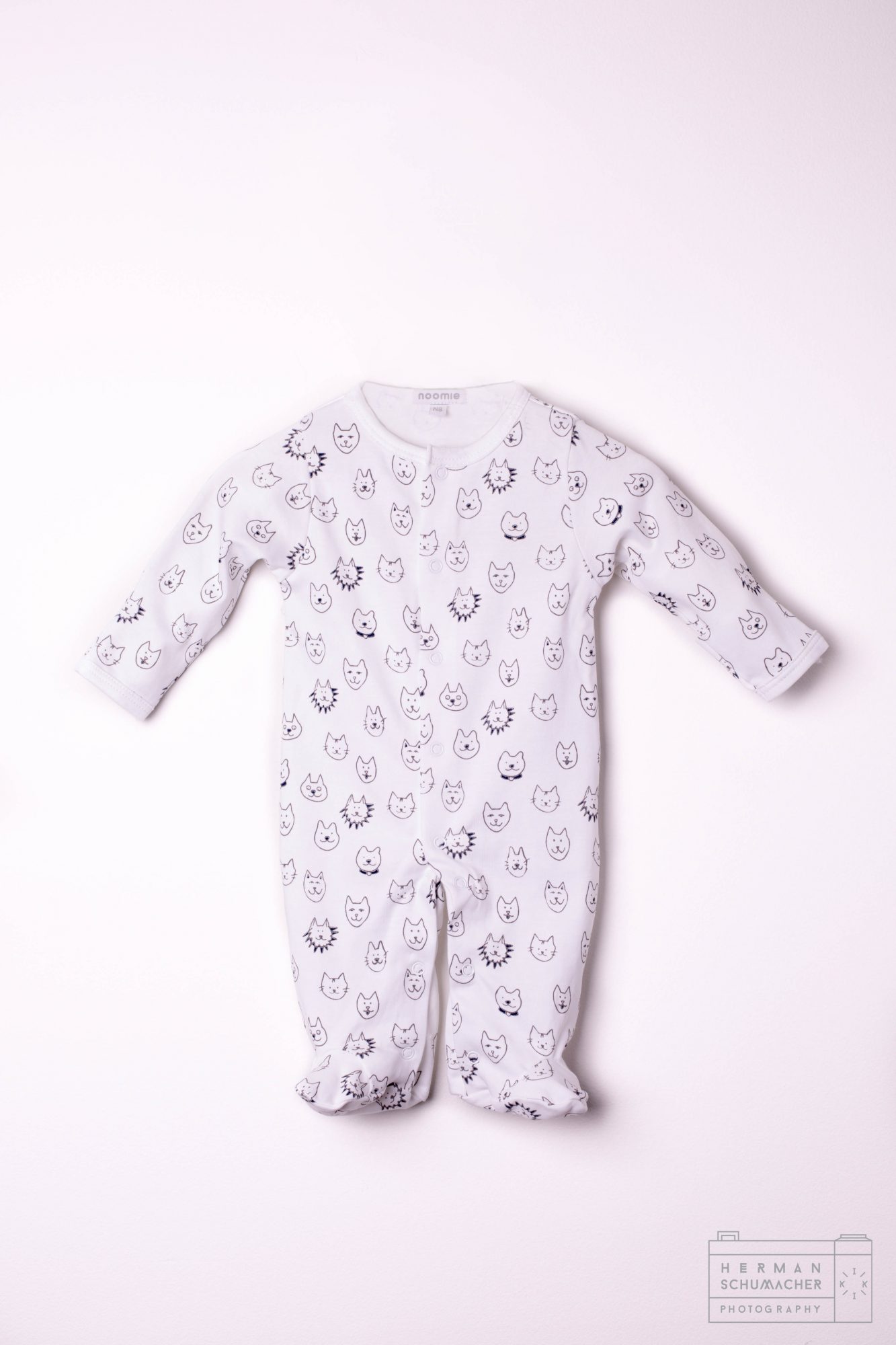 white baby noomie onesie with cats and lions